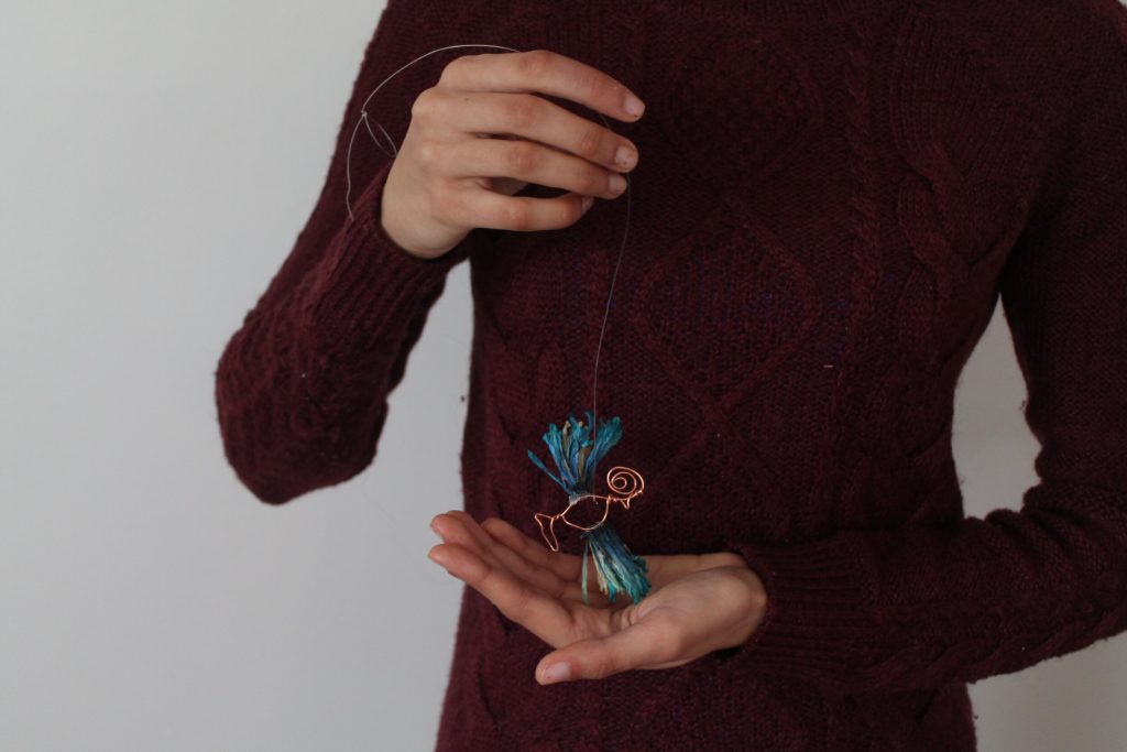   Nimra with a Huma bird created from copper wire and dried flower petals